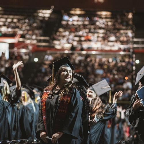 Graduates standing during the ceremony