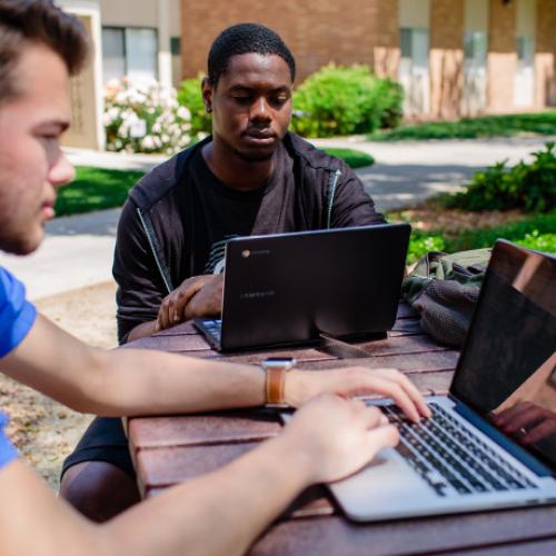 Photo of two students using computers.