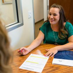 Woman helping girl fill out application