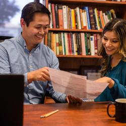 Photo of a student talking with an adult.